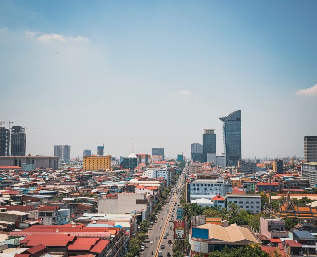 Discover the modern skyline and bustling streets of Phnom Penh from an aerial perspective.