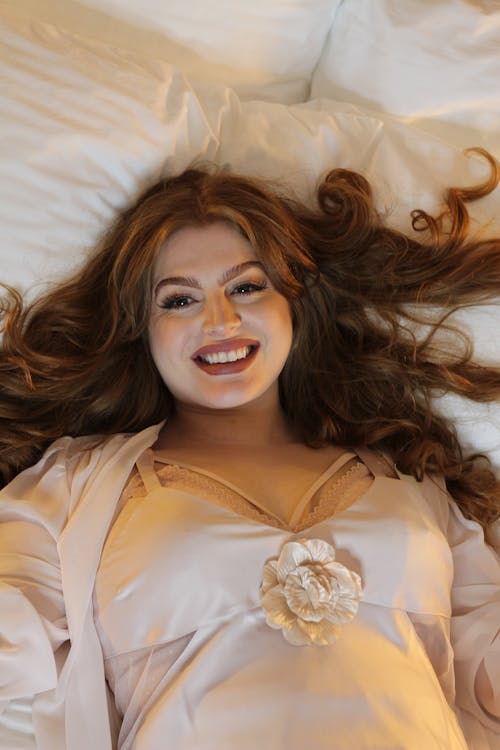Smiling Woman Posing on Bed