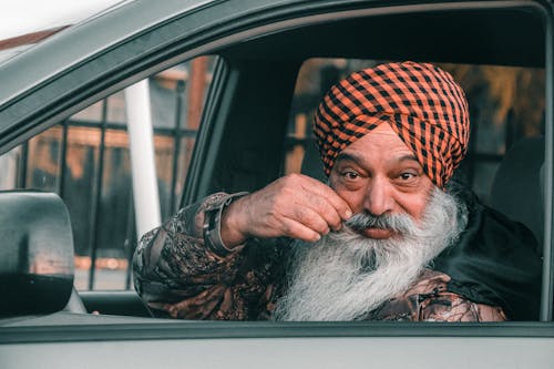 Man in Turban and with Beard Posing in Car