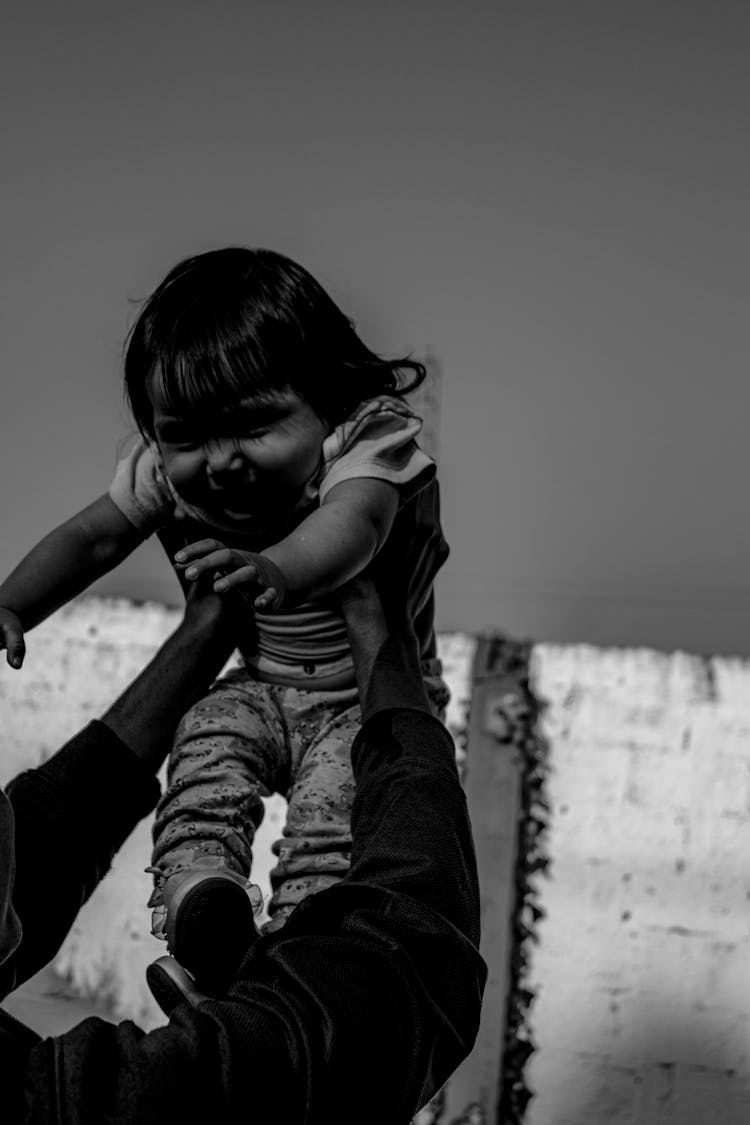 Parent Hands Holding Daughter In Black And White