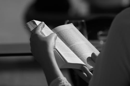 Hand Holding Book in Black and White