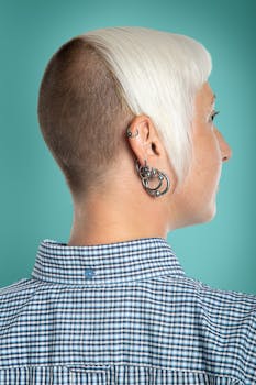 Stylish portrait of a woman with a modern short hairstyle and piercings.