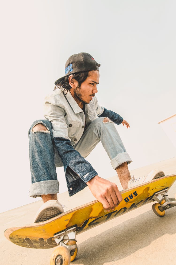 Young Man Riding On A Skateboard