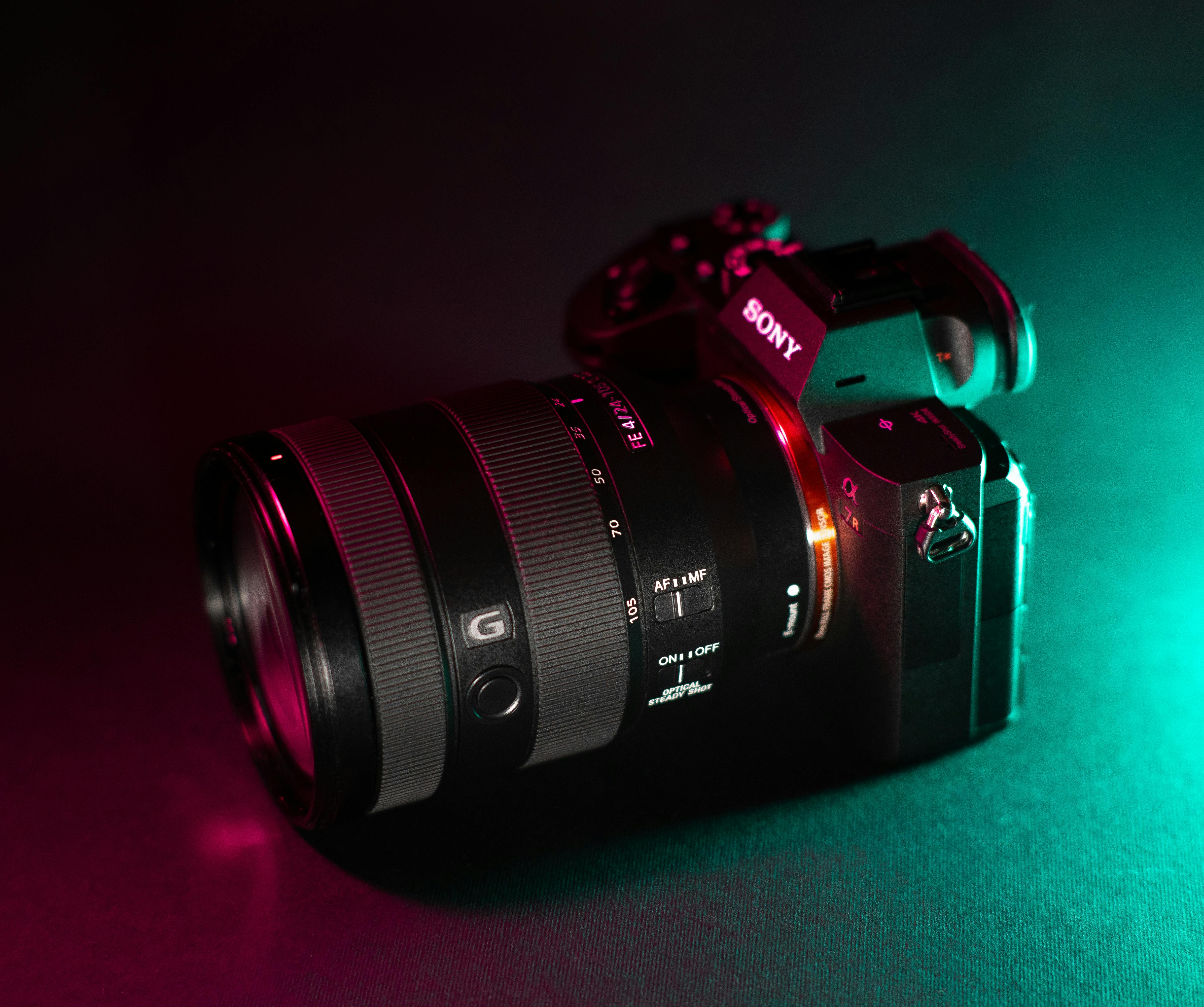 Free Close-up of a professional camera with artistic lighting on a black background. Stock Photo