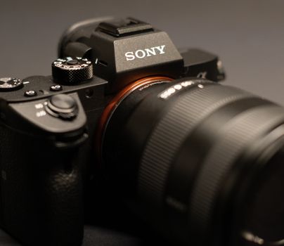 Detailed close-up of a modern digital camera with selective focus, perfect for technology enthusiasts.