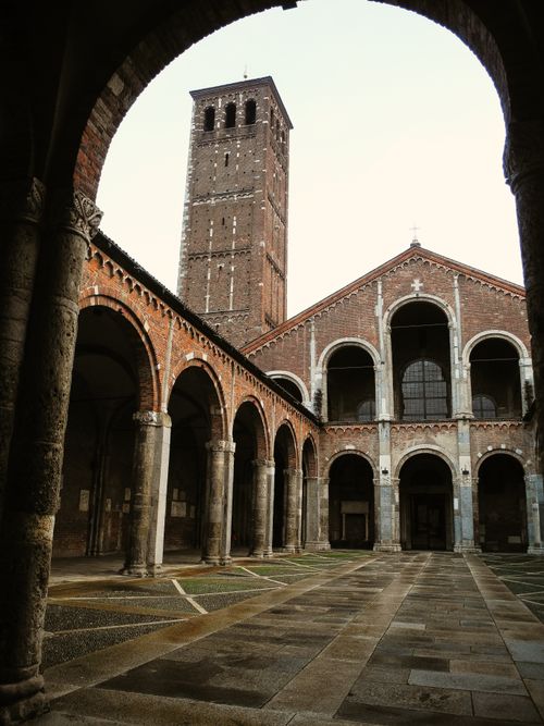 Free A historic church courtyard featuring a bell tower and arches, showcasing medieval architecture. Stock Photo