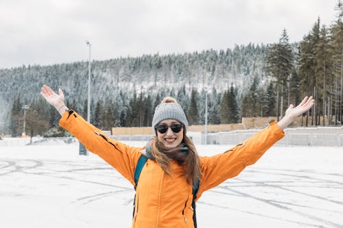 Woman Posing with Arms Raised in Winter