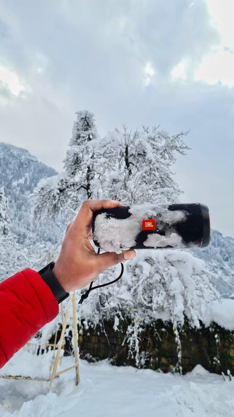 Hand Holding Frozen Item In Winter