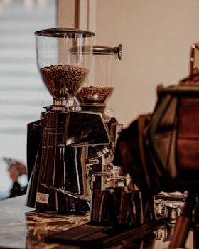 Close-up of a coffee grinder in a cafe showcasing freshly roasted beans.