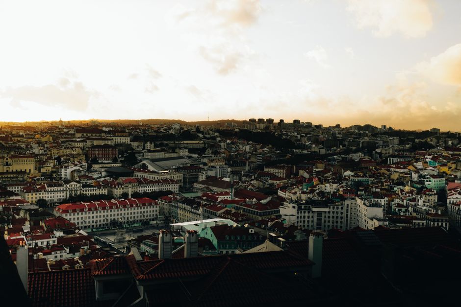 A breathtaking aerial view of Lisbon's cityscape at sunset, showcasing its iconic architecture.