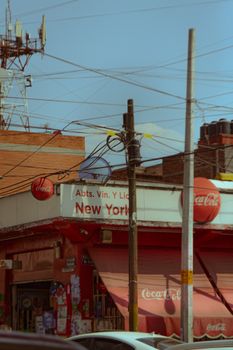 Vibrant street corner in Mexico City featuring a local store and bustling urban environment.