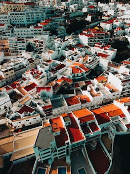 A stunning aerial view of Albufeira, Portugal, featuring vibrant red rooftops and coastal architecture.
