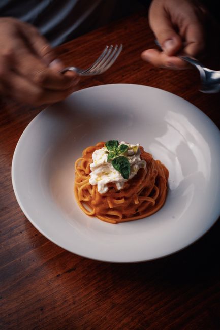 Close-up of a gourmet pasta dish with basil garnish, ready to be enjoyed.