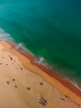 A stunning aerial shot capturing the vibrant Albufeira beach with turquoise waters and sandy shoreline.