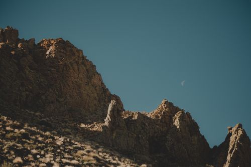 Free Barren rocky landscape under the clear sky of Santiago del Teide with a visible moon. Stock Photo