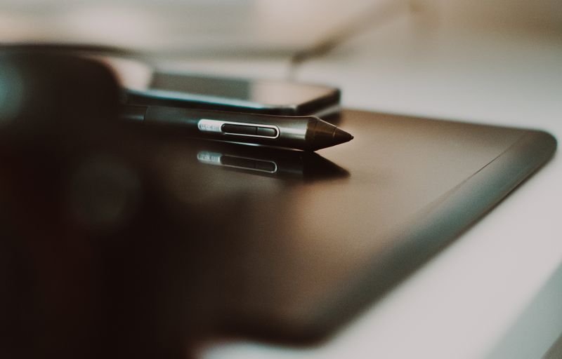 A stylus resting on a matte tablet on a desk — photo by Jakub Zerdzicki on Pexels