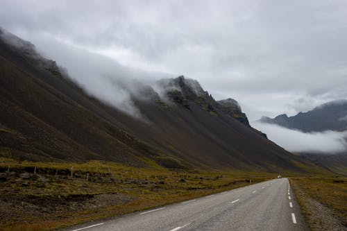 Clouds Covering Mountain Peaks next to a Road in Iceland 