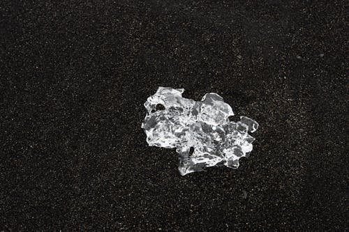 Free Close-up of Clear Ice on Black Sand  Stock Photo