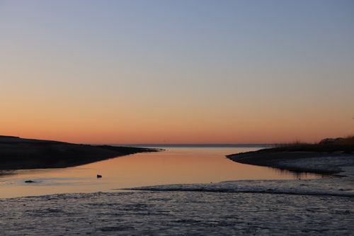 Free Peaceful sunset over calm waters at Cove Island Park, reflecting vibrant horizons. Stock Photo