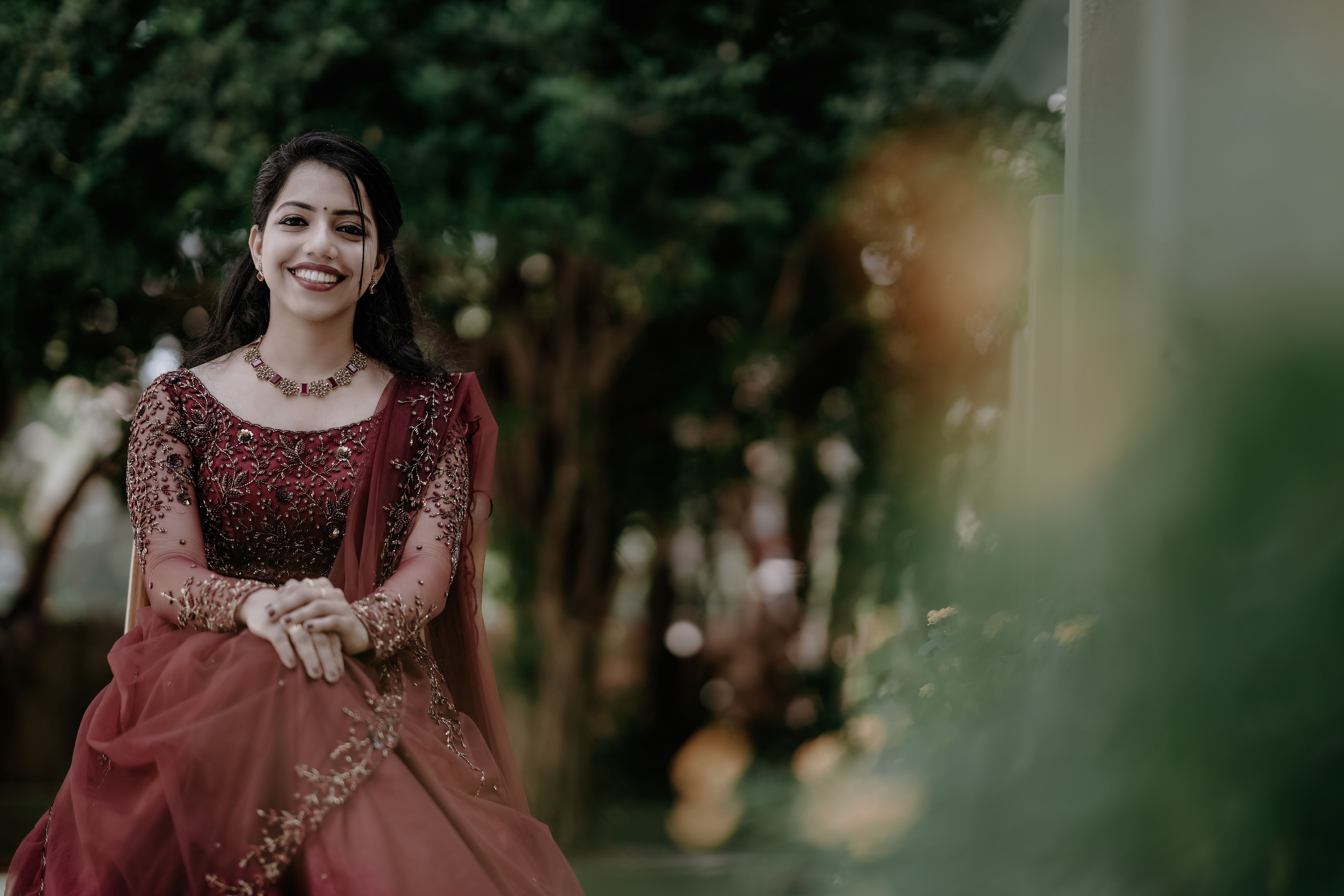 Smiling Woman Sitting in Traditional Dress · Free Stock Photo