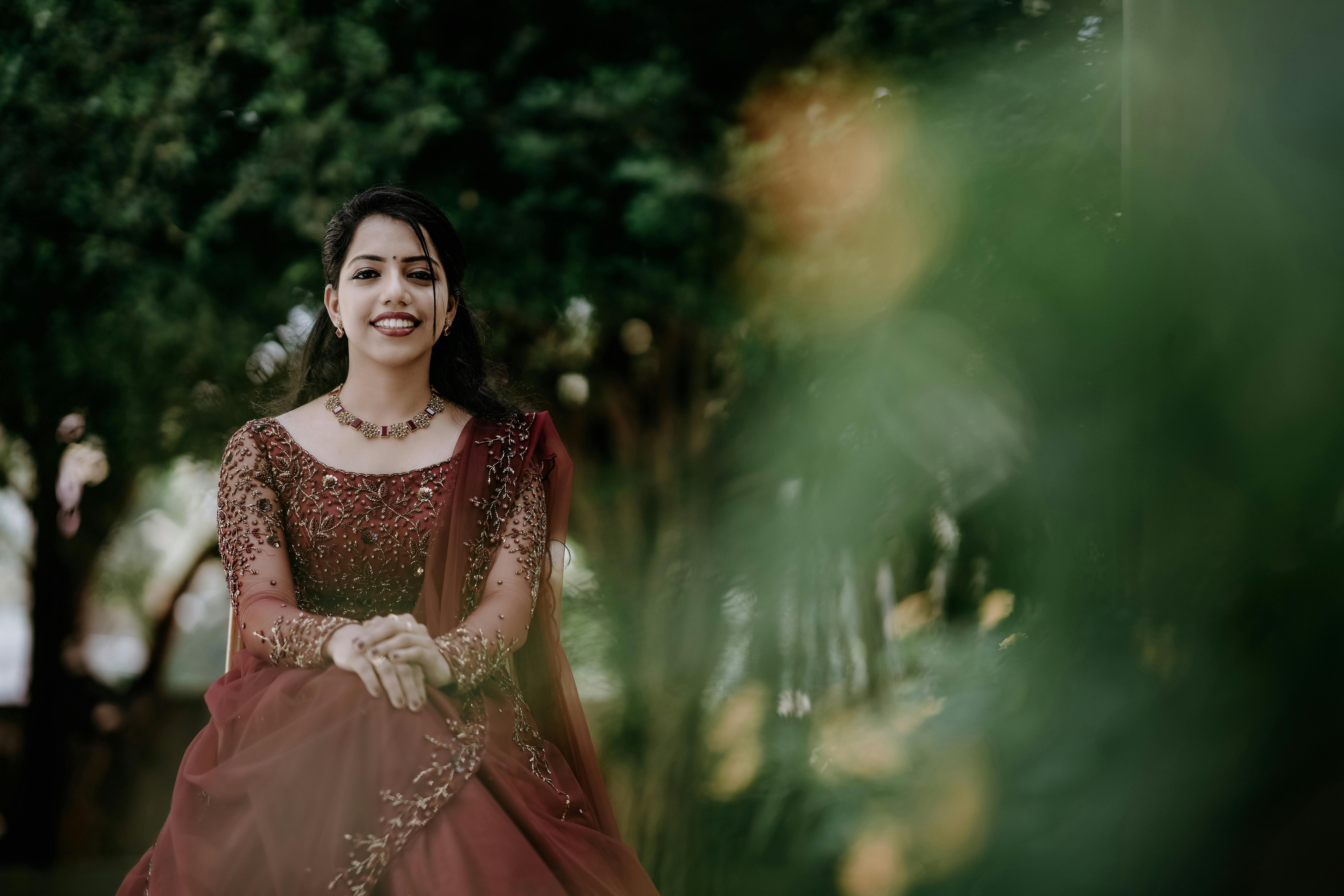 Young Woman Posing in a Traditional Golden Dress · Free Stock Photo
