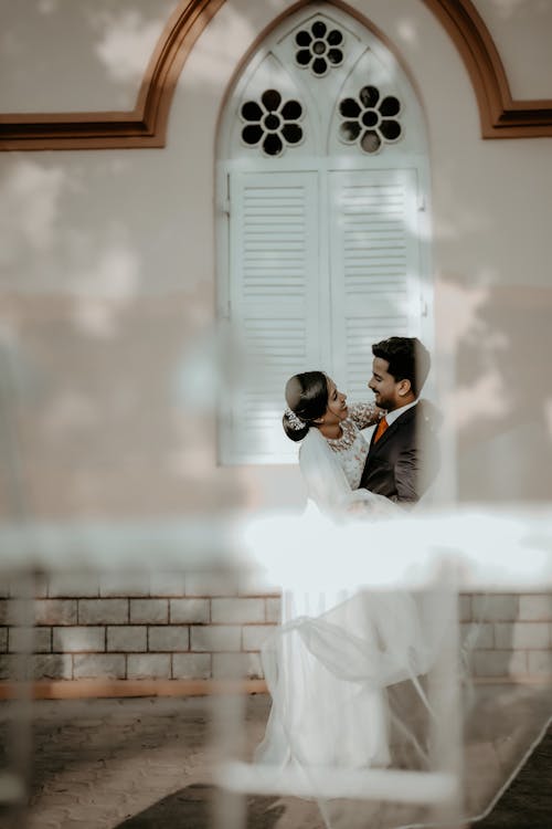 Newlyweds Together behind Window