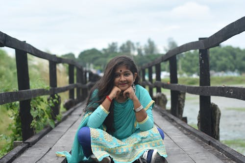 Girl sit in bridge