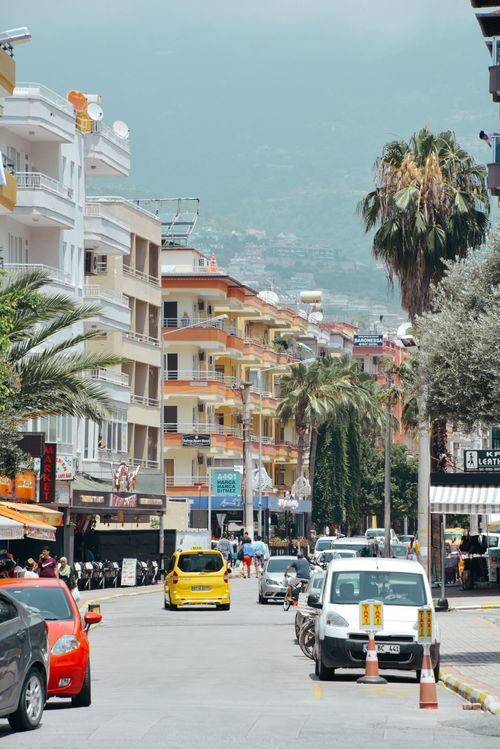Free Vibrant city street in Türkiye with traffic and palm trees, showcasing urban life. Stock Photo