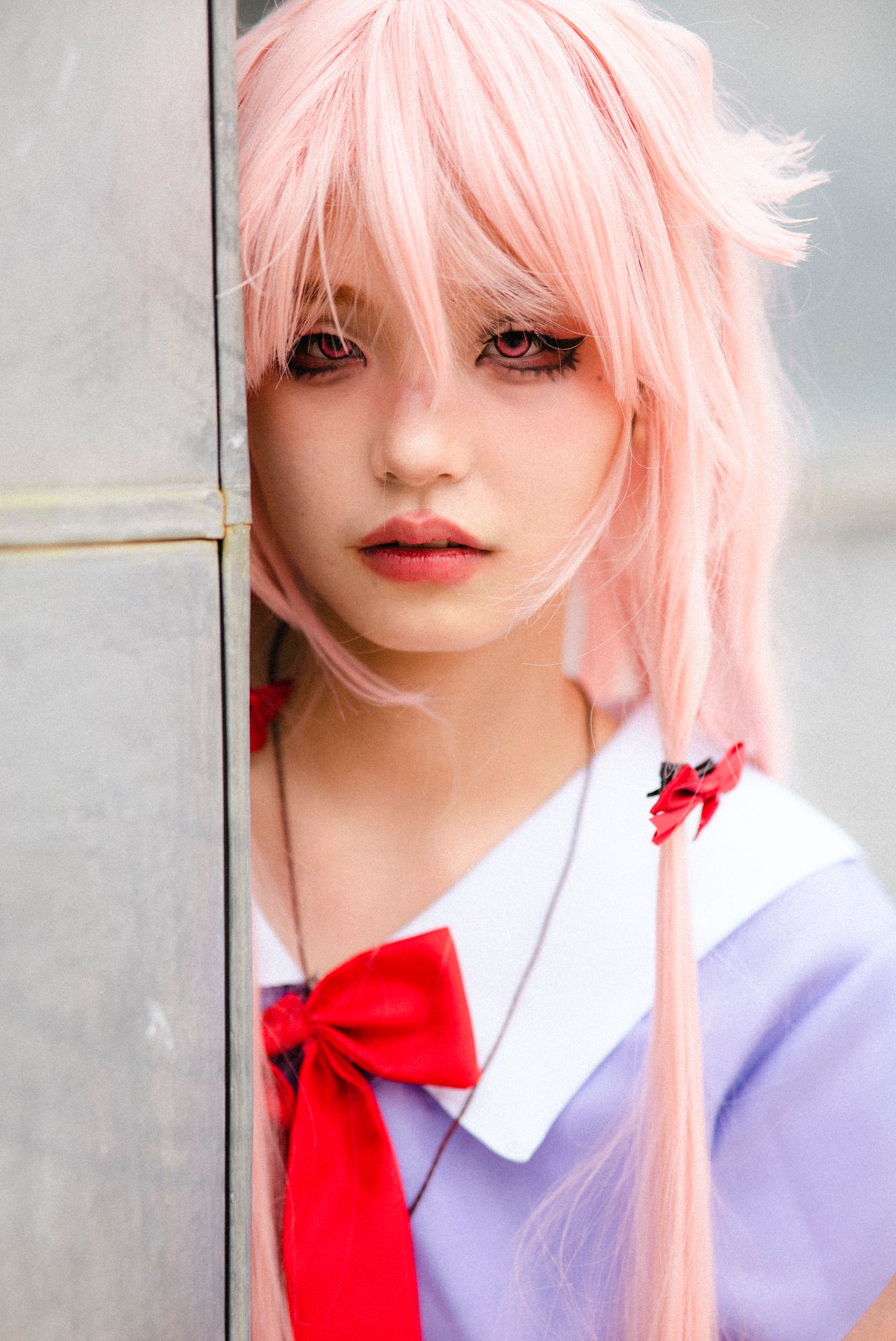 vibrant anime cosplay costume featuring a pink wig and red bow on a yo
