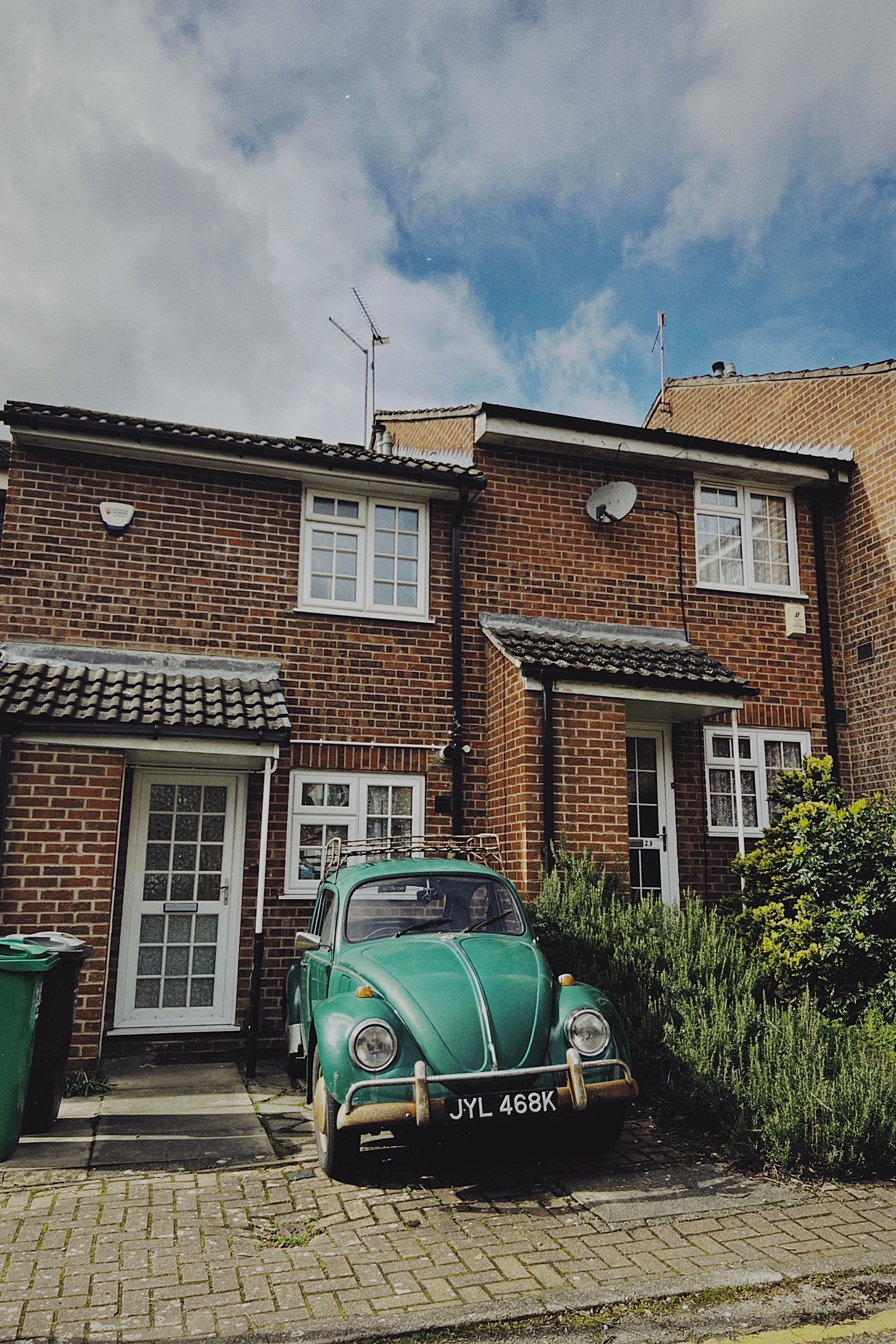 Vintage Car Parked in Front of a Residential Building · Free Stock Photo