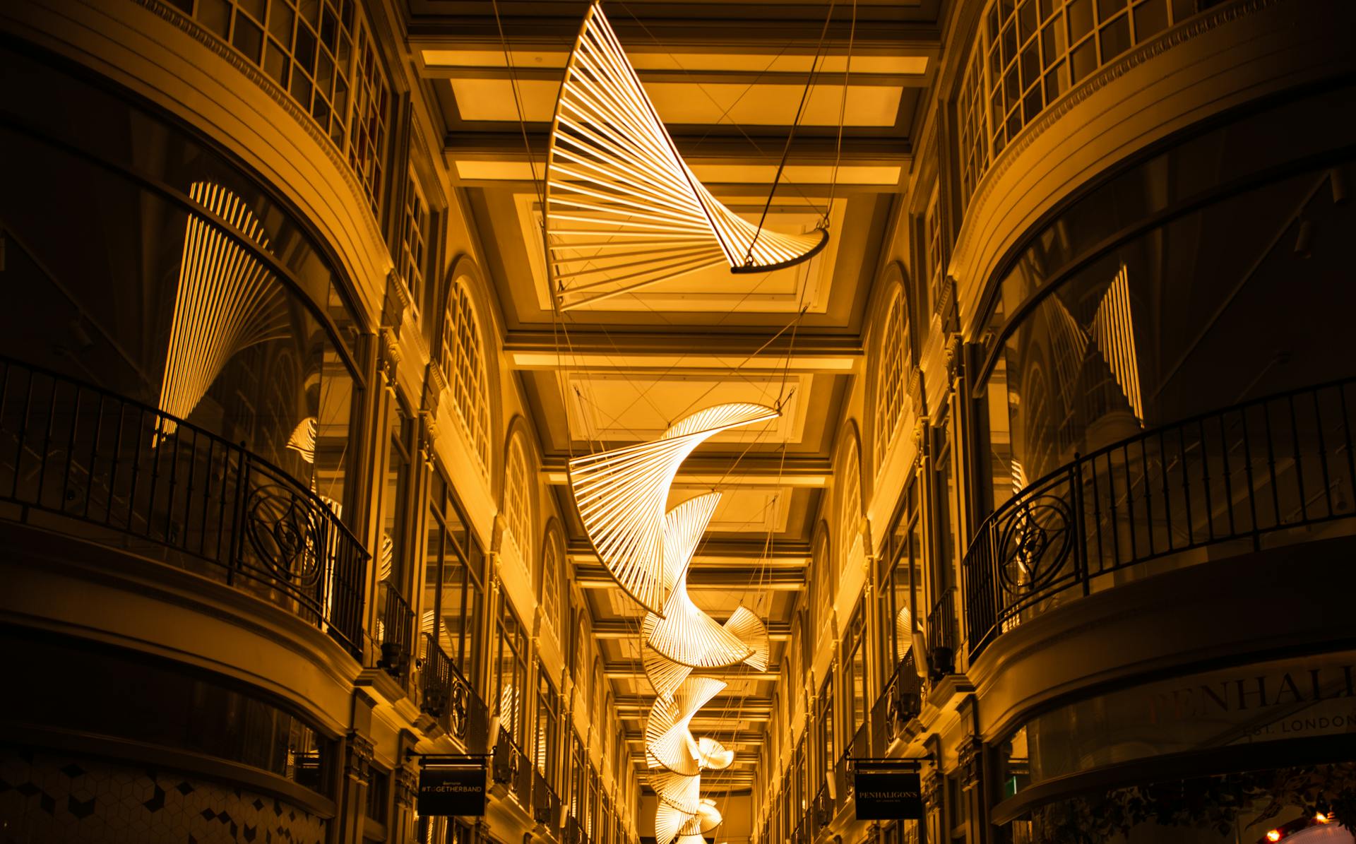 Elegant illuminated modern decorations in a London shopping arcade with classic architecture.