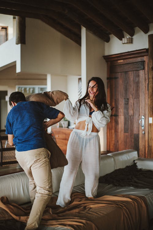 Happy Couple Play Fighting in a Living Room