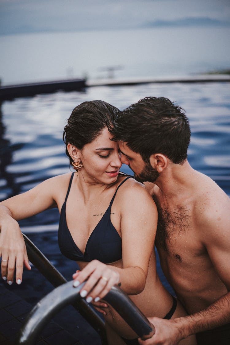 Young Couple Hugging In Water