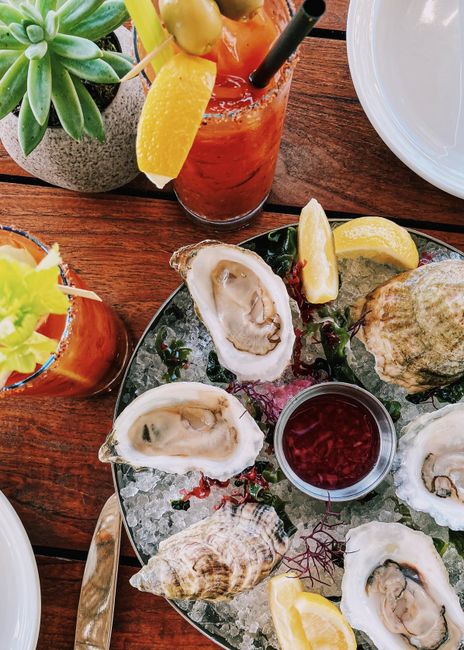 Refreshing seafood platter with oysters and Bloody Mary cocktails on a summer day in Miami Beach.