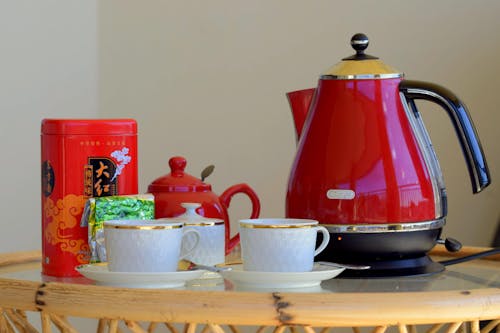 Red Kettle Beside White Teacups