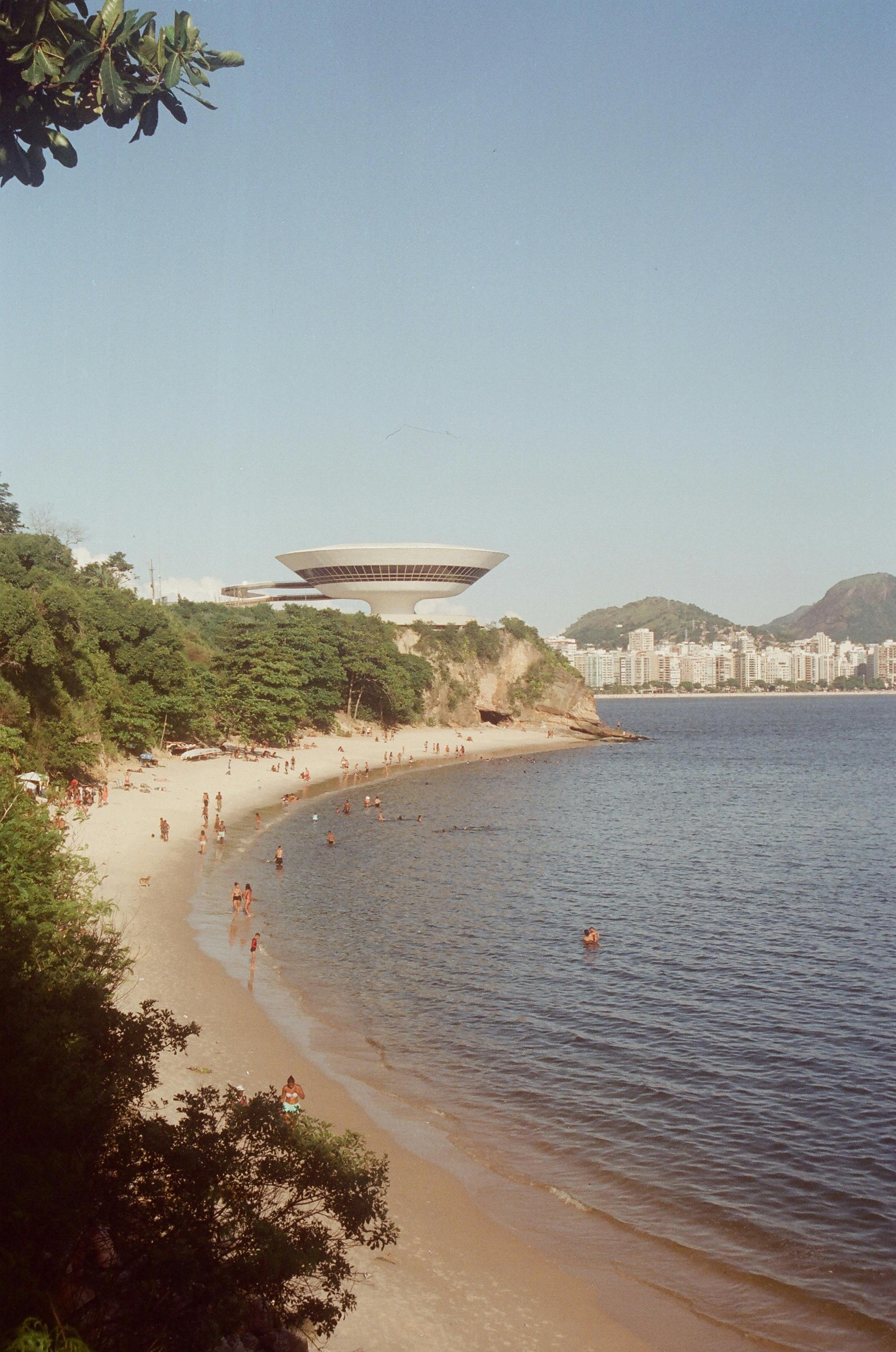View of a beach and MAC Niterói, an iconic contemporary museum, in Niterói, Brazil.