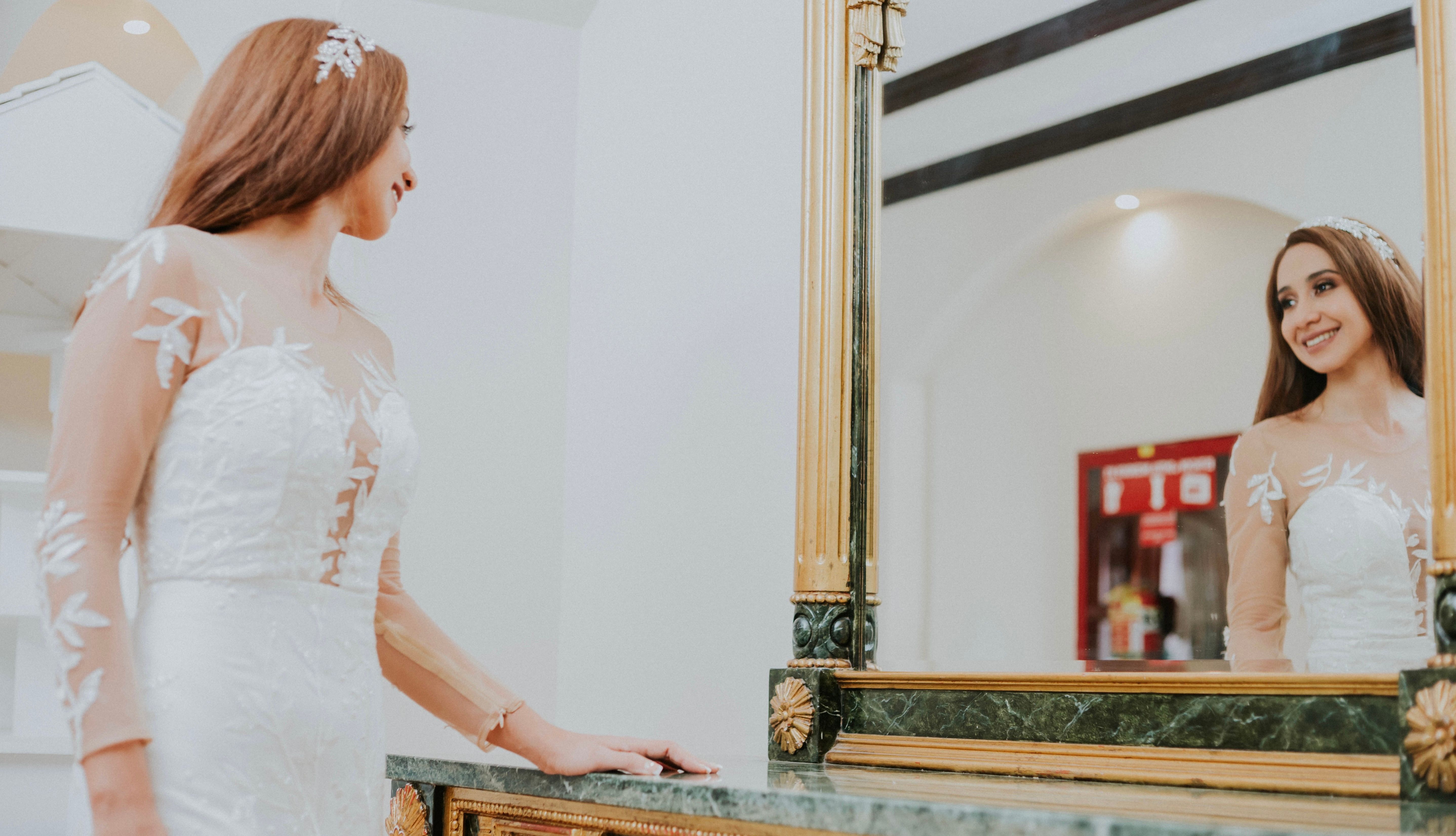 A bride admires her reflection in a mirror in Managua, Nicaragua. Elegant and serene.