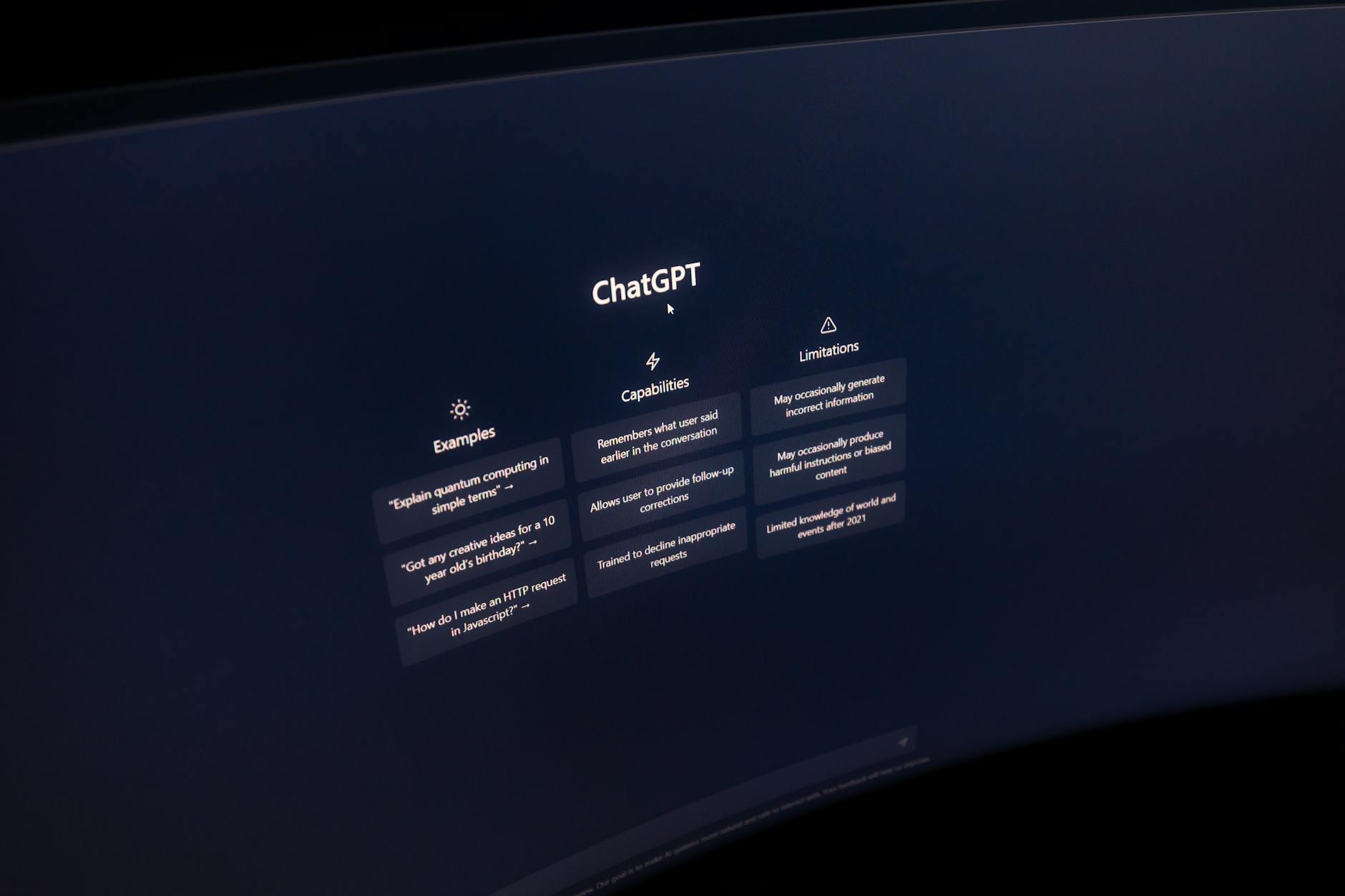 Close-up of a computer screen displaying ChatGPT interface in a dark setting.