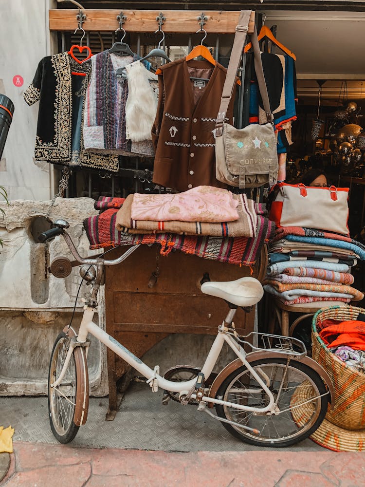 Urban Bike Standing By Clothing Street Stall