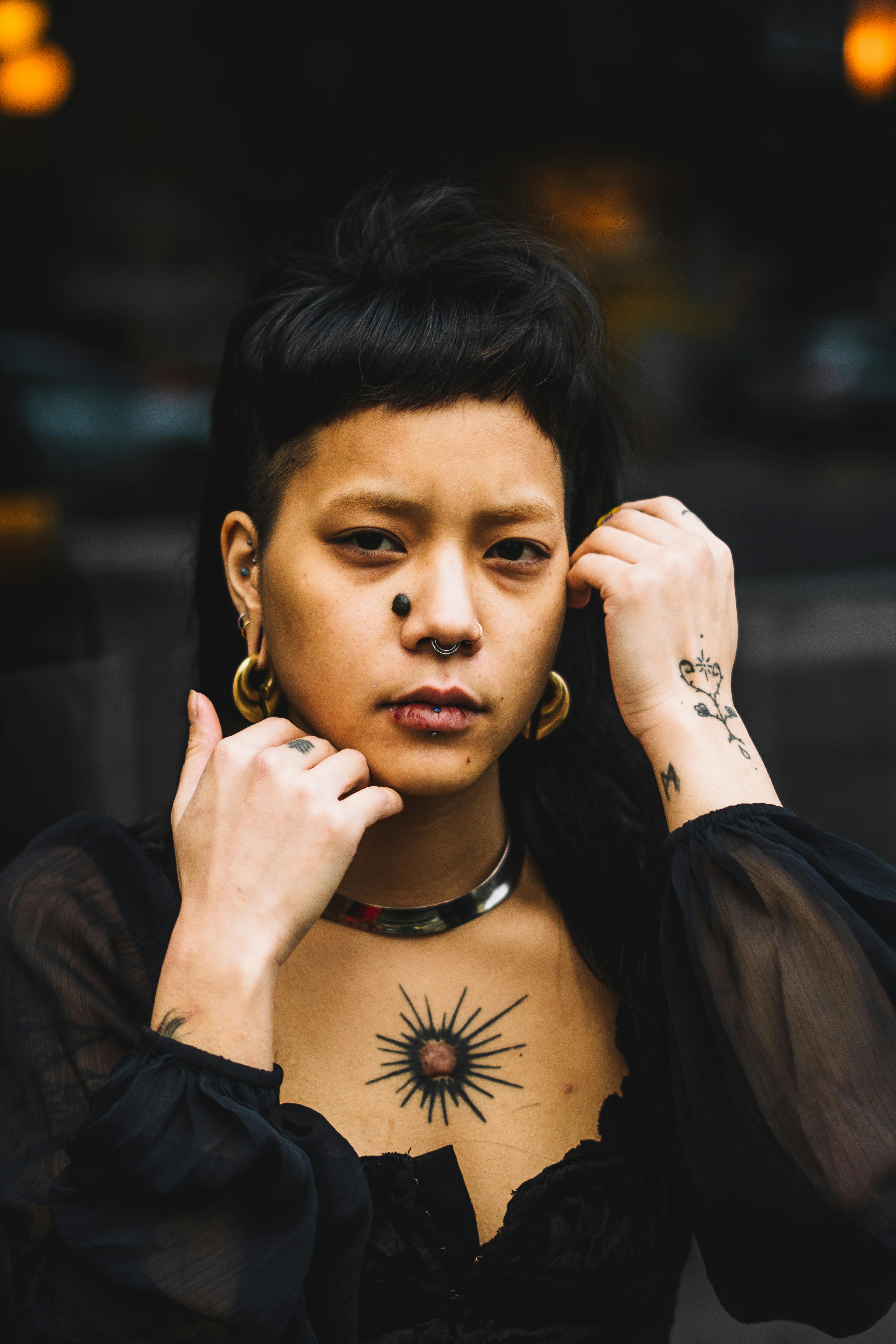 Photo of a Person with Piercings and Tattoos · Free Stock Photo