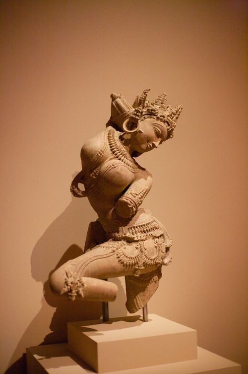 Free A beautifully detailed Hindu goddess statue displayed in an art exhibit with warm lighting. Stock Photo