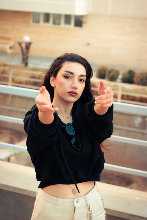 Portrait of Woman with Hands Raised