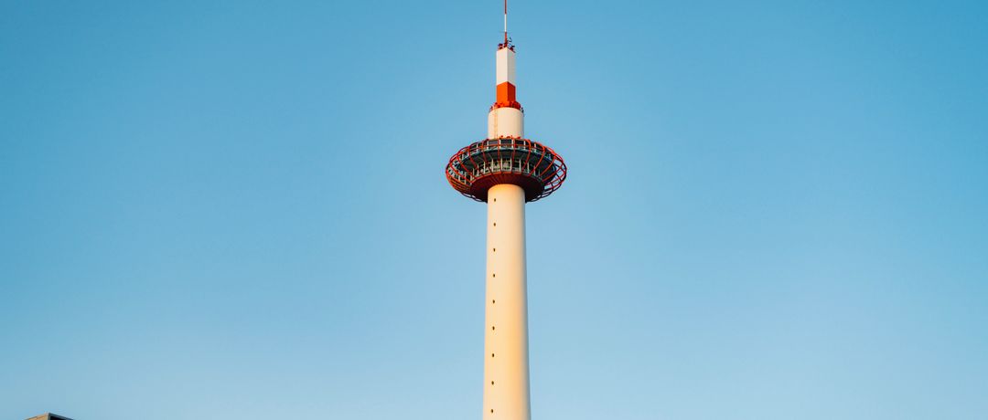 Kyoto Tower stands tall under a clear blue sky, showcasing modern architecture., Kyoto, Japan, stay connected here with a travel eSIM