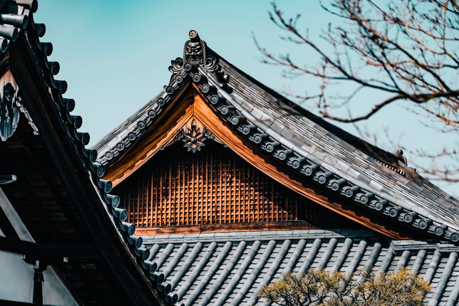 Close-up of traditional Japanese architecture roof with decorative patterns, showcasing cultural heritage.