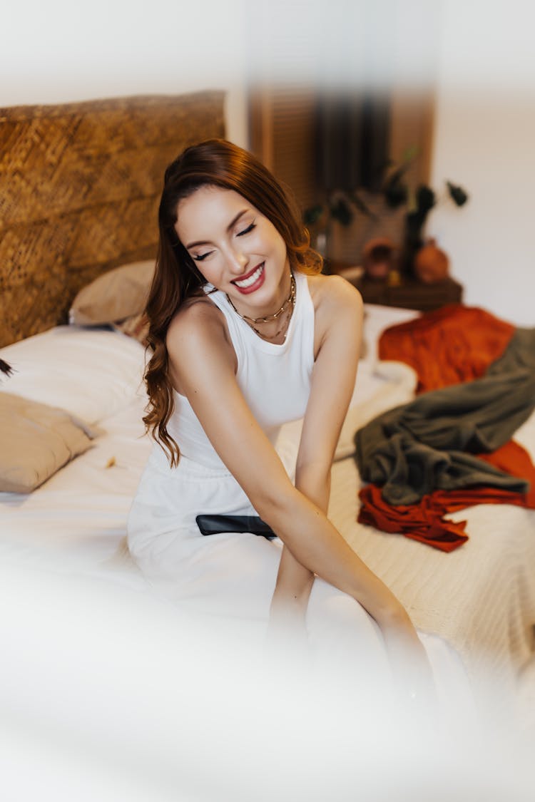 Smiling Woman Sitting On A Sofa