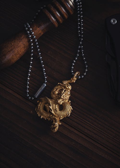 Close-up of a Dragon Pendant Lying on a Desk 