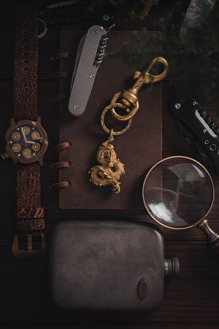 Top View Of A Dragon Pendant Lying On A Desk Among Other Items 