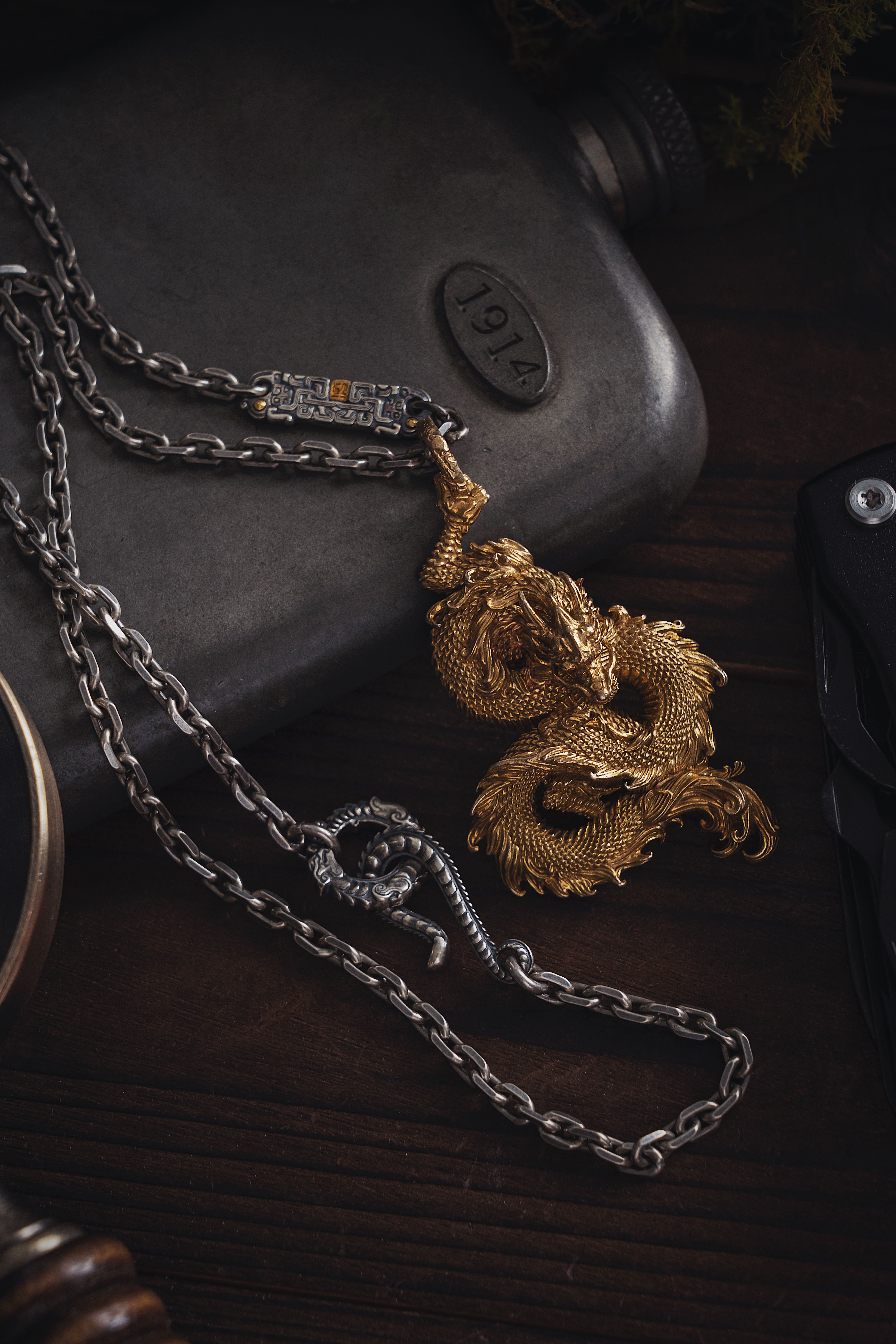 A Golden Dragon Pendant with a Silver Chain · Free Stock Photo