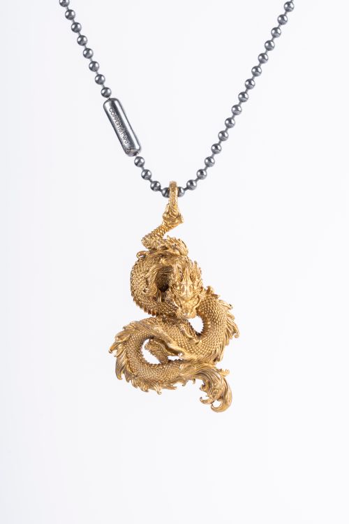 Free Stunning dragon necklace pendant in gold with intricate details, displayed on a white background. Stock Photo