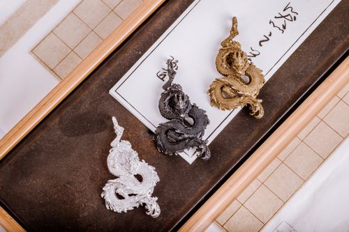 Free Elegant handmade dragon pendants in gold, silver, and oxidized finishes, showcasing detailed craftsmanship. Stock Photo